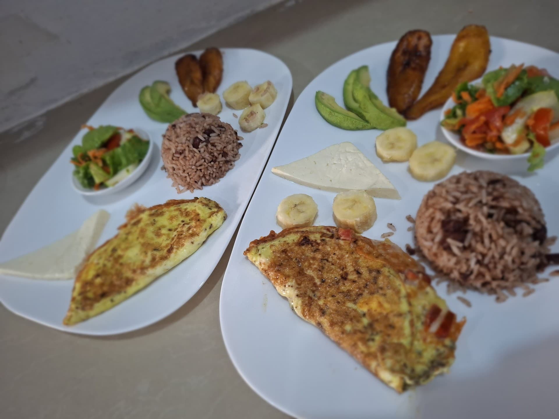 Two omelet breakfasts with gallo pinto, fresh salad, banana and fried plantain at Hotel Serendipity
